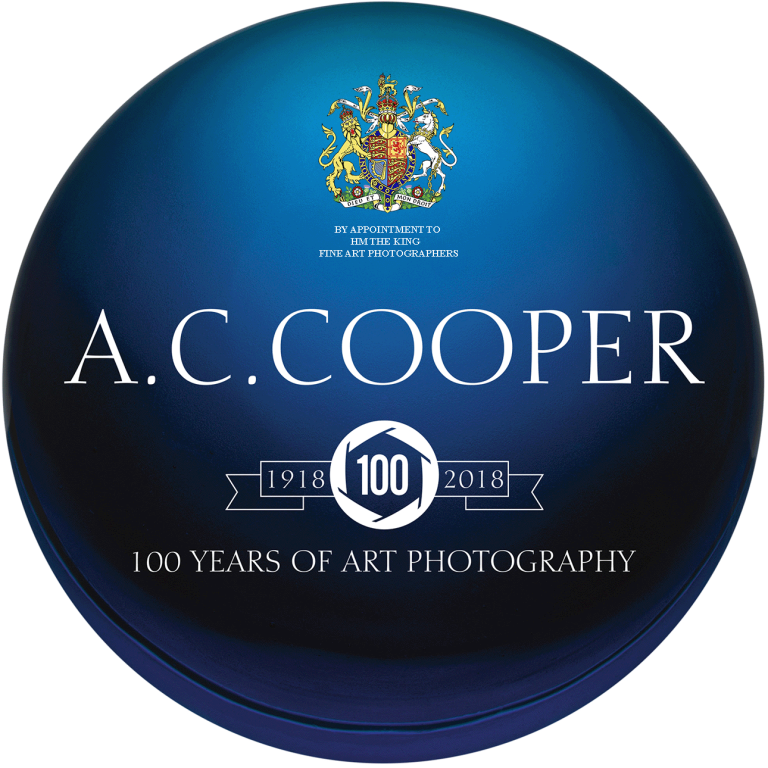 A blue glass globe with royal warrant, company logo and centenary legend depicted.