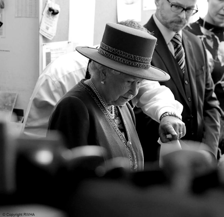 The Queen with Hamilton & Inches's QEST Apprentice Silversmith Paul Kirkos
